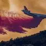 The 10 Tanker Air Carrier DC-10 jet drops fire retardant at the Holy Fire near Lake Elsinore, in Orange County, California, on August 7, 2018.
The fire began yesterday afternoon, August 6, in Holy Jim Canyon and grew to 4,000 acres by evening, on August 7, 2018. / AFP PHOTO / DAVID MCNEW