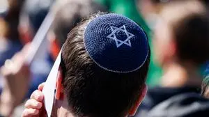 A participant wears a Kippa during a commemoration ceremony at the Bergen-Belsen Memorial in Lohheide, northern Germany on April 27, 2025, on the occasion of the 80th anniversary of the liberation of the Bergen-Belsen concentration camp. The Bergen-Belsen concentration camp was liberated by British forces on April 15, 1945. (Photo by FOCKE STRANGMANN / AFP)