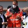 North Rhine-Westphalia's state premier and Christian Democratic Union (CDU) leader Armin Laschet (L) speaks with rescue teams managers as he visits the emergency accommodations for flood victims set up at the Ville Gymnasium school in Erftstadt, western Germany, on July 17, 2021, after a landslide in the town was triggered by floods following heavy rain that hit parts of the country. - Devastating floods in Germany and other parts of western Europe have been described as a "catastrophe", a "war zone" and "unprecedented", with more than 150 people dead and the toll still climbing on July 17, 2021. (Photo by SEBASTIEN BOZON / POOL / AFP)