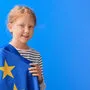 Little girl with flag of European Union on blue background
