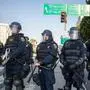 Protesters clash with law enforcement officers in the streets surrounding the federal building during a protest following federal immigration operations in Los Angeles, California, on June 8, 2025. Demonstrators torched cars and scuffled with security forces in Los Angeles on June 8, as police kept protestors away from the National Guard troops President Donald Trump sent to the streets of the second biggest US city. (Photo by RINGO CHIU / AFP)
