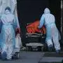 TOPSHOT - Bodies are moved to a refrigerator truck serving as a temporary morgue outside of Wyckoff Hospital in the Borough of Brooklyn on April 4, 2020 in New York. - New York state's coronavirus toll rose at a devastating pace to 3,565 deaths Saturday, the governor said, up from 2,935 the previous day, the largest 24-hour jump recorded there. (Photo by Bryan R. Smith / AFP)