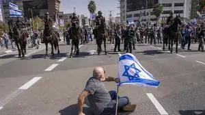Mounted police are deployed as Israelis block a main road to protest against plans by Prime Minister Benjamin Netanyahu's new government to overhaul the judicial system, in Tel Aviv, Israel, Wednesday, March 1, 2023. (AP Photo/Oded Balilty)