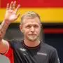 Haas F1's Danish driver Kevin Magnussen waves as he arrives to attend the Drivers Parade ahead of the Formula One Austrian Grand Prix on the Red Bull Ring race track in Spielberg, Austria, on June 30, 2024. (Photo by Jure Makovec / AFP)