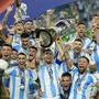 Argentina's Lionel Messi holds the trophy as celebrating with teammates after defeating Colombia in the Copa America final soccer match in Miami Gardens, Fla., Monday, July 15, 2024. (AP Photo/Rebecca Blackwell)