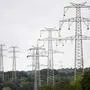 General view taken as workers of electricity transmission operator TransnetBW assemble a 380-KV power line on a high-voltage power pole near Pforzheim, southern Germany, on August 3, 2023. TransnetBW operates the electricity transmission grid in Federal state Baden-Wuerttemberg and expands it with a new 12 kilometers long  high-voltage line near this city. (Photo by THOMAS KIENZLE / AFP)