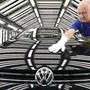 FILE - In this Nov. 9, 2012 file photo worker Michael Keil checks a  Golf VII car during a press tour at the plant of the German car manufacturer Volkswagen AG (VW) in Zwickau, central Germany. Volkswagen AG says Wednesday, July 29, 2015, that profits slipped by 16 percent in the second quarter. (AP Photo/Jens Meyer,File)