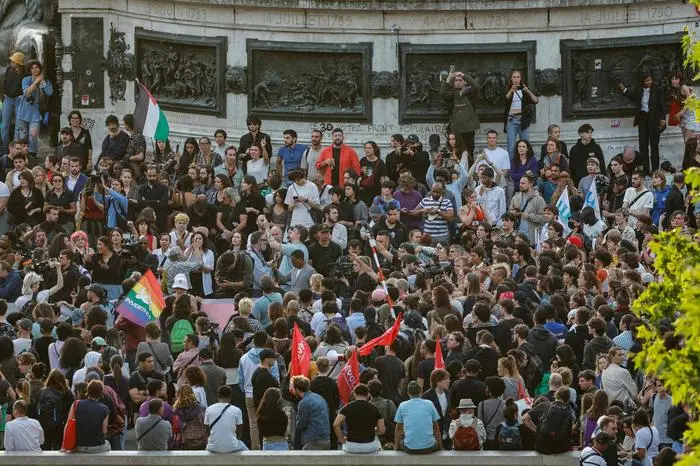 Demonstrators take part in a rally after the announcement of the results of the first round of French parliamentary elections, at Place de la Republique in Paris on June 30, 2024. A divided France is voting in high-stakes parliamentary elections that could see the anti-immigrant and eurosceptic party of Marine Le Pen sweep to power in a historic first. The candidates formally ended their frantic campaigns at midnight June 28, with political activity banned until the first round of voting. (Photo by Geoffroy VAN DER HASSELT / AFP)