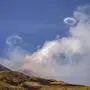 Volcanic vortex rings emerge from a new pit crater on the north side of the southeast crater of the Etna Volcano in Sicily, Italy, Friday, April 5, 2024. While the physical conditions under which volcanic vortex rings form are still not entirely known, scientists believe they are the result of a combination of fast gas release at the top of the magma conduit and regularity in the shape of the emitting vent. (AP Photo/Giuseppe Di Stefano)