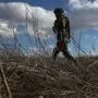 A serviceman of Ukrainian Military Forces walks on position on the front line with Russia backed separatists not far Novognativka village, Donetsk region, on February 19, 2022. (Photo by Anatolii STEPANOV / AFP)