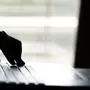 A hand reaching out through a laptop computer and signifying a cybercrime in internet theft while using online, Payment Security Concept. anonymous Hacked in Black
