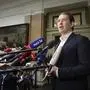 Former Austrian Chancellor Sebastian Kurz, center, talks to the media before appearing at court on the first day of his trial in Vienna, Austria, Wednesday, Oct. 18, 2023. Kurz is charged with making false statements to a parliamentary inquiry into alleged corruption in his first government. (AP Photo/Heinz-Peter Bader)