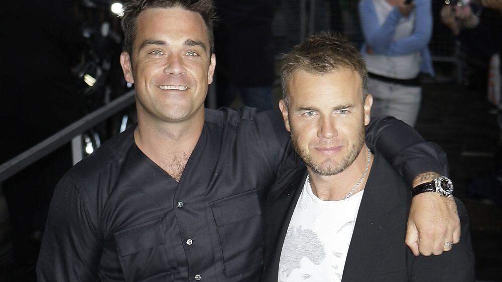 Gary Barlow (rechts) hatt mit Bandkollegen Robbie Williams viele Aufs und Abs