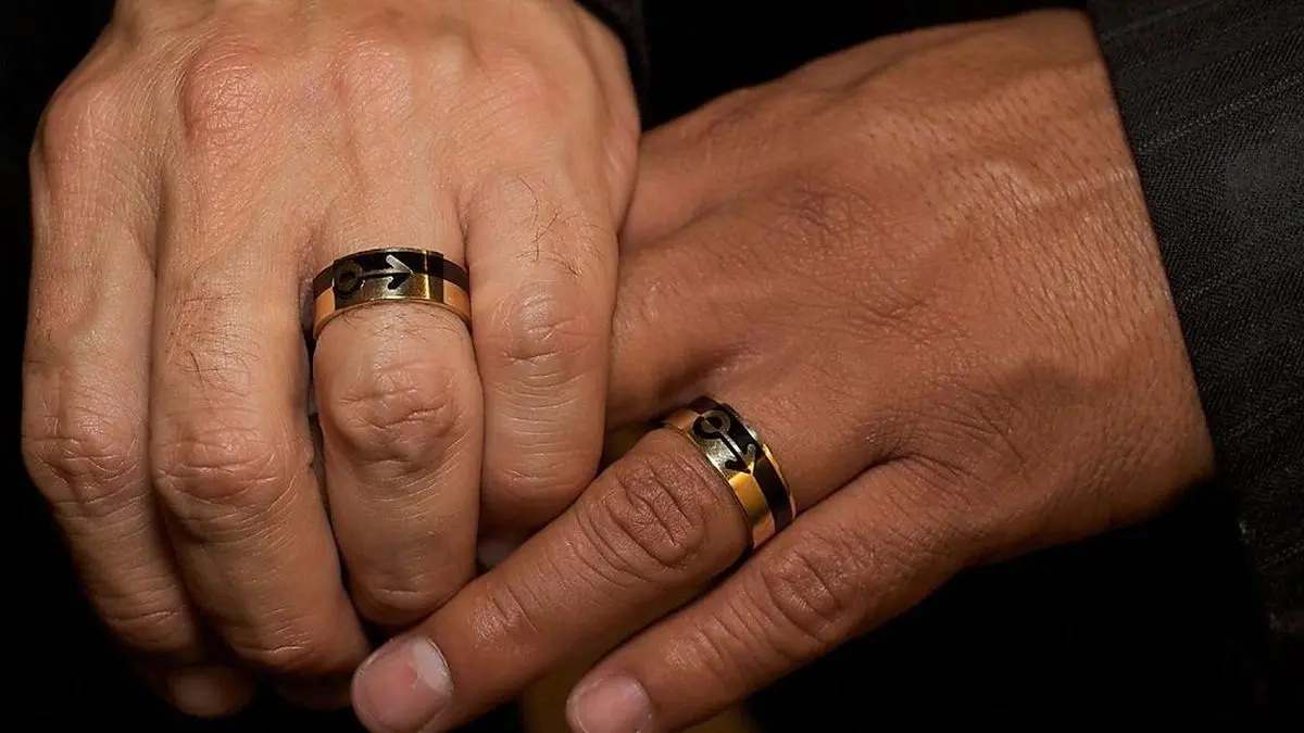 Same-sex couple's hands: Eric Manriquez, left, and Juan Rivera hold their gold wedding rings together, as they get married in East Los Angeles on Tuesday, June 17, 2008. The celebration of their union is celebrated at the home of iconic labor leader United Farm Workers founder Cesar Chavez's granddaughter, Christine Chavez, the first day wedding licenses are available to gay and lesbian couples in Los Angeles County. (AP Photo/Damian Dovarganes)