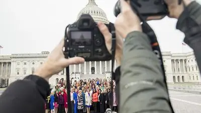 Photographers hold their cameras up as House Speaker Nancy Pelosi of Calif., center, poses with all House Democratic women members of the 116th Congress on the East Front Capitol Plaza on Capitol Hill in Washington, Friday, Jan. 4, 2019, as the 116th Congress begins. (AP Photo/Andrew Harnik)