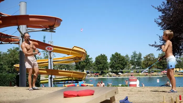 Vater und Sohn ins Spiel vertieft – so sieht der Sommer im Freibad Fürstenfeld aus