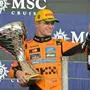 TOPSHOT - McLaren's British driver Lando Norris celebrates with the trophy and champagne after winning the Sao Paulo Formula One Grand Prix at the Jose Carlos Pace racetrack, aka Interlagos, in Sao Paulo, Brazil on November 9, 2025. (Photo by Nelson ALMEIDA / AFP)
