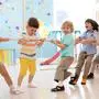 group of preschool kids play and pull rope together in daycare