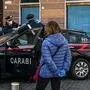 Italian Carabinieri policemen check the self-certification documents of people in Piazza San Cosimato in the district of Trastevere in Rome on March 20, 2020 during the country's lockdown aimed at stopping the spread of the COVID-19 (new coronavirus) pandemic. (Photo by ANDREAS SOLARO / AFP)