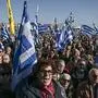 Residents of the island of Lesbos wave Greek national flags as they take part in a demonstration against migrant camps, at the port of Mytilene on January 22, 2020. - Thousands of residents on Greek islands hosting large migrant camps on January 22 kicked off a day of protests, demanding the immediate removal of asylum-seekers. The islands of Lesbos, Samos and Chios staged a general strike, shutting down shops and public services and rallying in central squares, many protesters waving Greek flags. (Photo by ARIS MESSINIS / AFP)