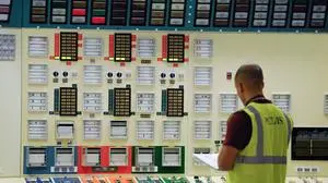(FILES) This file photo taken on November 14, 2013 shows an employee of EDF (Electricity of France), a French electric utility company, working in a control room simulator at the Fessenheim nuclear powerplant during a nuclear accident simulation in Fessenheim.  
France took on January 24, 2017 a key step towards shutting down its oldest nuclear power station, a campaign promise of Socialist President Francois Hollande, just months before he leaves office. The board of state-owned electricity utility EDF approved a compensation package worth at least 400 million euros ($430 million) for the shutdown of the Fessenheim nuclear plant, a source close to the matter said. / AFP PHOTO / SEBASTIEN BOZON