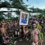 TOPSHOT - Villagers from Iaohnanen and Yakel on Vanuatu's Tanna island pose with a portrait Britain's King Charles III on May 6, 2023, ahead of the coronations in London of Britain's King Charles III and Britain's Camilla, Queen Consort. (Photo by Ben BOHANE / AFP)