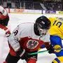 RED DEER,CANADA,23.DEC.21 - ICE HOCKEY - OEEHV international under-20 test match, Sweden vs Austria. Image shows Marco Kasper (AUT) and Alexander Holtz (SWE).  Photo: GEPA pictures/ Bildbyran/ Joel Marklund - ATTENTION - COPYRIGHT FOR AUSTRIAN CLIENTS ONLY - FOR EDITORIAL USE ONLY