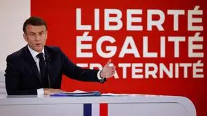 France's President Emmanuel Macron gestures as he speaks during a press conference to present the course for France's newly appointed government at The Elysee Palace in Paris on January 16, 2024. The press conference, aired on several television channels at prime time, is the first such question-and-answer session hosted by the French President for almost five years. (Photo by Ludovic MARIN / AFP)