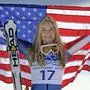 FILE - Bronze medalist Lindsey Vonn of the United States hold the Stars and Stripes during the flower ceremony for the Women's super-G at the Vancouver 2010 Olympics in Whistler, British Columbia, Feb. 20, 2010. (AP Photo/Gero Breloer, File)