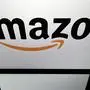(FILES) In this file photo taken on April 19, 2018 shows the logo of online retail comapny Amazon displayed on a tablet screen in Paris. - Online retail giant Amazon announced on October 2, 2018 it would raise its starting wage for US workers to $15 an hour, amid long-standing criticism of low pay, and advocate for a higher minimum wage nationwide.The pay raise will apply to 250,000 employees, starting November 1, and to the more than 100,000 seasonal workers the company expects to hire for the holiday shopping season. (Photo by Lionel BONAVENTURE / AFP)