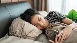 peer pressure. young teenage asian girl feel depress while using her mobile phone at home