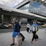 Passengers walk on the grounds of Moscow's Vnukovo International Airport on September 7, 2023. (Photo by Natalia KOLESNIKOVA / AFP)