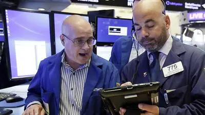 Specialist Anthony Confusione, left, and trader Fred DeMarco work on the floor of the New York Stock Exchange, Friday, Aug. 31, 2018. Stocks are opening mostly lower on Wall Street, led by declines in banks and energy companies. (AP Photo/Richard Drew)