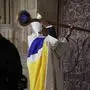 TOPSHOT - Archbishop of Paris, Bishop Ulrich, knocks on the door of Notre-Dame Cathedral during a ceremony to mark the re-opening of the landmark Cathedral, in central Paris, on December 7, 2024. Around 50 heads of state and government are expected in the French capital to attend the ceremony marking the rebuilding of the Gothic masterpiece five years after the 2019 fire which ravaged the world heritage landmark and toppled its spire. Some 250 companies and hundreds of experts were part of the five-year restoration project at a cost of hundreds of millions of euros. (Photo by Christophe PETIT TESSON / POOL / AFP)
