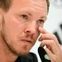 Julian Nagelsmann | Germany's head coach Julian Nagelsmann wipes his eye as he gives a press conference at the team's base camp in Herzogenaurach on July 6, 2024 a day after their defeat against Spain during the quarter-finals of the Euro 2024 football competition. (Photo by Tobias SCHWARZ / AFP)