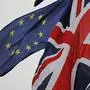 An EU Flag flown by an anti-Brexit protester is seen with a Union Flag set on a flag pole in Parliament sq1uare in front of the Houses of Parliament in London on January 30, 2020. - Britain will leave the European Union formally at 2300GMT on January 31, 2020. (Photo by Tolga AKMEN / AFP)