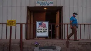 (FILES) In this file photo taken on November 03, 2020 a man walks out after casting his vote at the American Legion in Tombstone, Arizona. - Victory in elections hinges on offering the right answers to questions that matter most. But voters shifting priorities have been harder than usual to pin down in this years US midterms campaign (Photo by ARIANA DREHSLER / AFP)