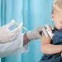Pediatrician makes vaccination to small girl