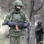 epa04109690 Armed men in military uniform stand outside the territory of a Ukrainian military unit in the village of Perevalnoye, outside Simferopol, Ukraine, 04 March 2014. The Russian army reportedly occupied key sites in the autonomous region of Crimea, where a majority of the population is ethnic Russian. Troops surrounded several small military outposts and demanded Ukrainian troops disarm.  EPA/MAXIM SHIPENKOV