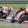 MotoGP rider from Australia, Casey Stoner on a Ducati (27), is followed closely by Spain's Dani Pedrosa (26) on his Honda and Italy's Marco Melandri on a Honda during the Malaysian Grand Prix motorcycle race at Sepang international circuit in Sepang, Malaysia, Sunday, Oct. 21, 2007 which was won Stoner. (AP Photo/Wong Maye-E)