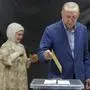 Turkish President Recep Tayyip Erdogan, right, followed by his wife Emine, casts his ballots at a polling station during the second round of the presidential election in Istanbul, Sunday, May 28, 2023. Voters in Turkey returned to the polls Sunday to decide whether the country’s longtime leader, Erdogan, stretches his increasingly authoritarian rule into a third decade, or is unseated by a challenger who has promised to restore a more democratic society. (Murad Sezer/Pool Photo via AP)