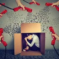 Stressed young business woman sitting hiding in a box overwhelmed by too many red telephone calls and errands should be done. Busy day of an employee concept; sujet