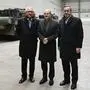 German Chancellor Olaf Scholz (C), German Defence Minister Boris Pistorius (R) and CEO of Rheinmetall Armin Papperger pose in front of Leopard 2 tanks as they visit a production line at the future site of an arms factory where weapons maker Rheinmetall plans to produce artilleries from 2025, in Unterluess, Germany February 12, 2024. (Photo by FABIAN BIMMER / POOL / AFP)
