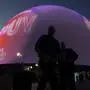 People stand outside during the opening night of the Sphere, Friday, Sept. 29, 2023, in Las Vegas. (AP Photo/John Locher)