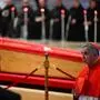 Giovanni Angelo Becciu walks next to the coffin after paying his respects during a ceremony inside St Peter's Basilica following the procession of the late Pope's coffin from the chapel of Santa Marta to St Peter's Basilica, in the Vatican on April 23, 2025. The Pope died of a stroke, the Vatican announced hours after the death on April 21, 2025, of the 88-year-old reformer who inspired devotion but riled traditionalists during 12 years leading the Catholic Church. (Photo by Tiziana FABI / AFP)