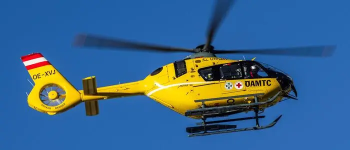 Gelber Rettungshubschrauber vor blauem Himmel