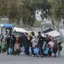 Migrants arrive at the port of Mytilene in the Greek island of Lesbos on March 20, 2020 to be transfered in a closed camp in northern Greece as the country is battling hard to control the novel coronavirus that causes COVID-19 infection and also racing to avoid contagion among tens of thousands of migrants in overcrowded camps nationwide, a situation recently termed a "health bomb" by government spokesman. (Photo by Manolis Lagoutaris / AFP)