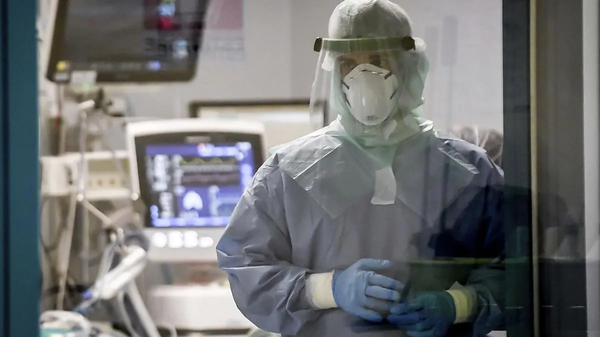 In this photograph taken from behind a window, a doctor works in a Covid-19 intensive care unit of San Matteo Hospital, in Pavia, northern Italy, Thursday, March 26, 2020. The San Matteo hospital is where Patient 1, a 38-year-old Unilever worker named Mattia, was kept since he tested positive for Covid-19 on Feb. 21 and opened Italy’s health care crisis. The new coronavirus causes mild or moderate symptoms for most people, but for some, especially older adults and people with existing health problems, it can cause more severe illness or death. (Claudio Furlan/LaPresse via AP)