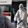 Operators sanitize each other after service on an ambulance for the transport of COVID-19 patients in Settimo Torinese, Northern Italy, Monday, March 23, 2020. For most people, the new coronavirus causes only mild or moderate symptoms. For some it can cause more severe illness, especially in older adults and people with existing health problems. (Fabio Ferrari/LaPresse via AP)