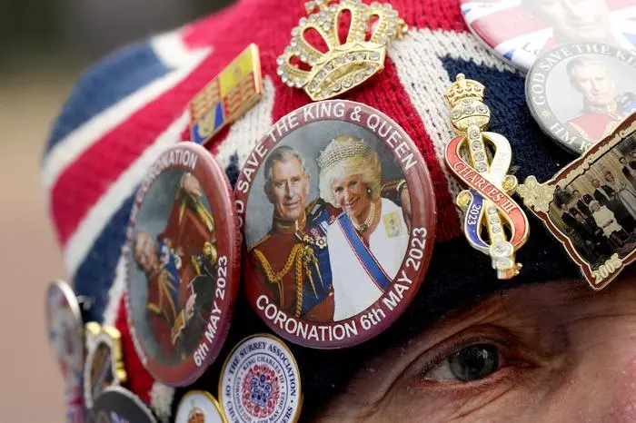 Royal fan John Loughrey speaks to passerby along the King's coronation route at The Mall in London, Tuesday, May 2, 2023. The coronation of King Charles III will takes place at Westminster Abbey on May 6. (AP Photo/Frank Augstein)